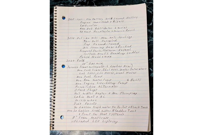 Slide: The Image of Handwritten maintenance notes for a 1987 Luhrs 30 Alura Classic boat on lined paper. - 31
