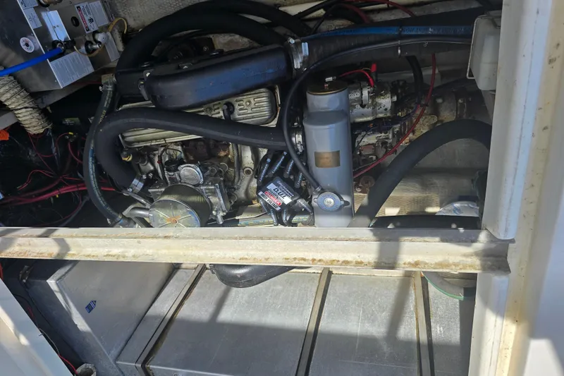 Slide: The Image of Engine compartment of 1987 Luhrs 30 Alura Classic boat, showing detailed mechanical components. - 33