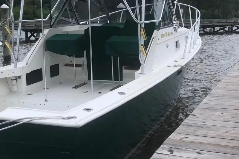 Slide: The Image of 1987 Luhrs 30 Alura Classic boat docked by wooden pier. - 36