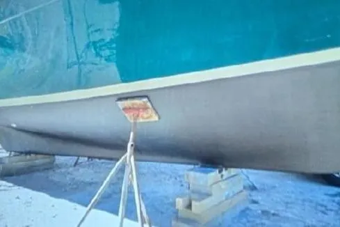 Slide: The Image of 1987 Luhrs 30 Alura Classic boat on dry dock, supported by stands. - 38