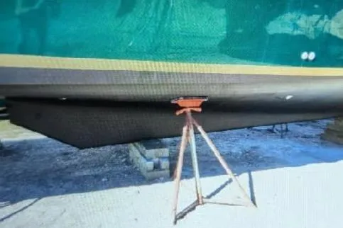 Slide: The Image of 1987 Luhrs 30 Alura Classic boat hull on support stand, side view. - 39