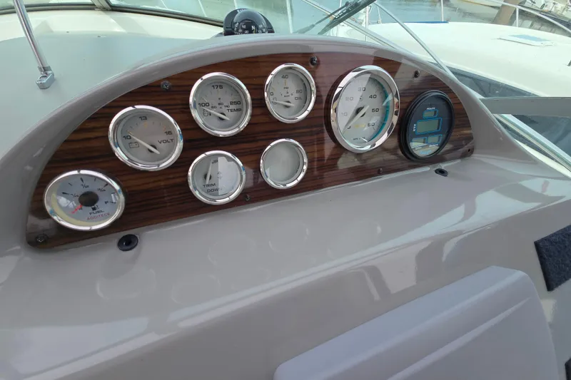 Slide: The Image of Dashboard of a 2011 Bayliner 285 boat with various gauges and controls. - 11
