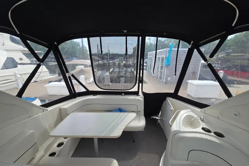 Slide: The Image of Interior view of 2011 Bayliner 285 boat with seating and table, dockside. - 13