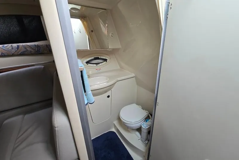 Slide: The Image of 2011 Bayliner 285 boat interior bathroom with toilet, sink, and mirror. - 19