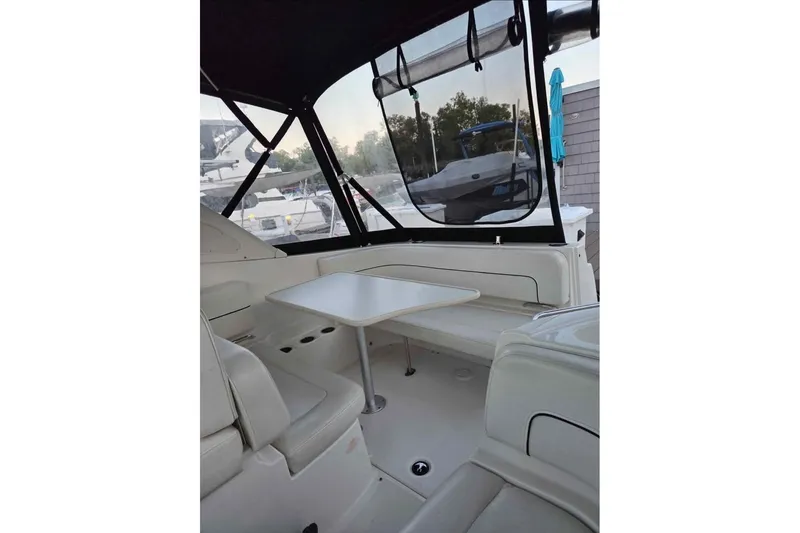 Slide: The Image of 2011 Bayliner 285 boat docked at marina, featuring sleek design and covered cockpit. - 2