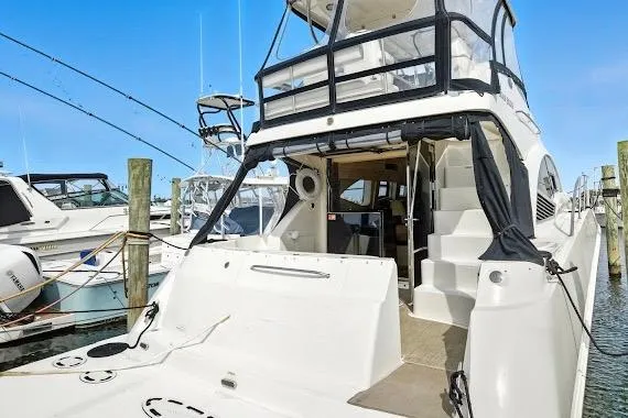 Slide: The Image of 2008 Sea Ray 47 Sedan Bridge yacht docked at marina, rear view. - 10