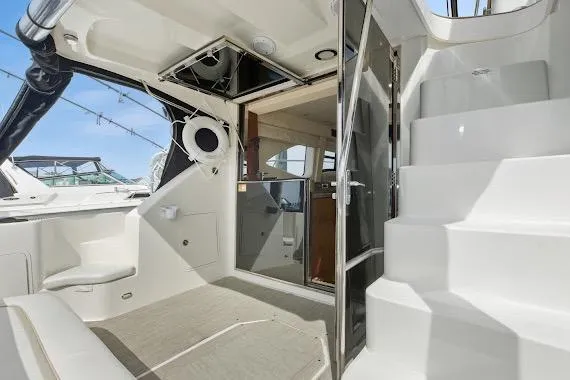 Slide: The Image of 2008 Sea Ray 47 Sedan Bridge yacht interior with stairs and seating area. - 12