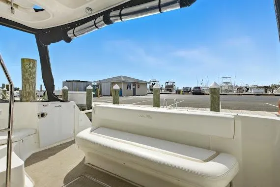 Slide: The Image of 2008 Sea Ray 47 Sedan Bridge yacht interior with marina view, featuring white seating. - 13