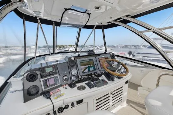 Slide: The Image of 2008 Sea Ray 47 Sedan Bridge helm with advanced navigation systems and panoramic marina view. - 14