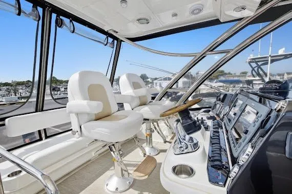 Slide: The Image of 2008 Sea Ray 47 Sedan Bridge helm with modern controls and comfortable seating. - 16