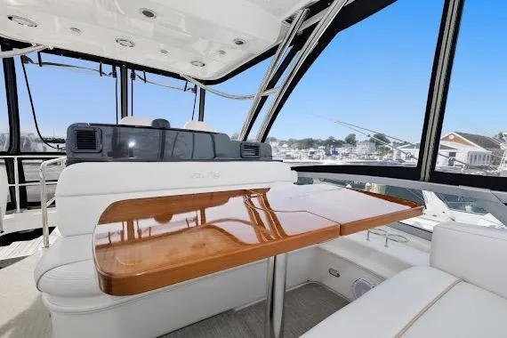 Slide: The Image of Luxurious interior of 2008 Sea Ray 47 Sedan Bridge yacht with elegant seating and table. - 19