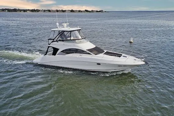 Slide: The Image of 2008 Sea Ray 47 Sedan Bridge yacht cruising on open water. - 2