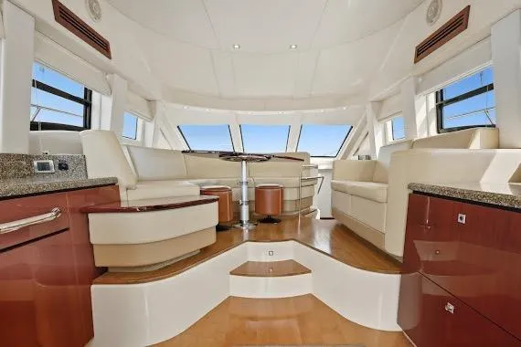 Slide: The Image of Luxurious interior of 2008 Sea Ray 47 Sedan Bridge yacht with elegant seating and panoramic windows. - 26