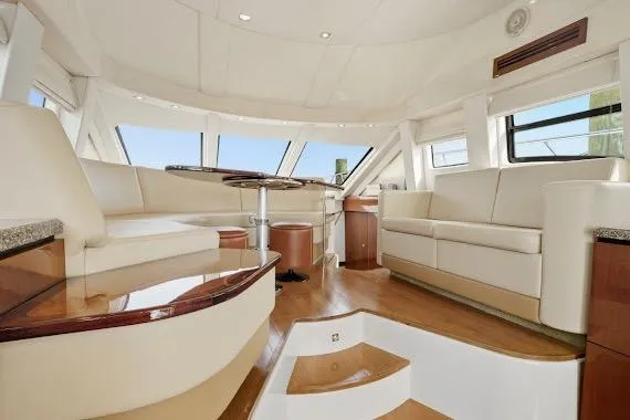 Slide: The Image of Luxurious interior of 2008 Sea Ray 47 Sedan Bridge yacht with elegant seating and panoramic windows. - 28