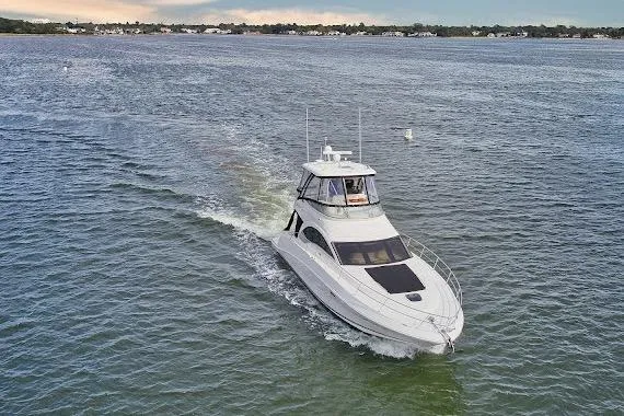 Slide: The Image of 2008 Sea Ray 47 Sedan Bridge yacht cruising on open water. - 3