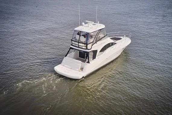 Slide: The Image of 2008 Sea Ray 47 Sedan Bridge yacht cruising on open water. - 4