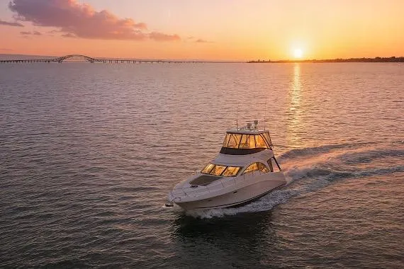 Slide: The Image of 2008 Sea Ray 47 Sedan Bridge yacht cruising at sunset on open water. - 46