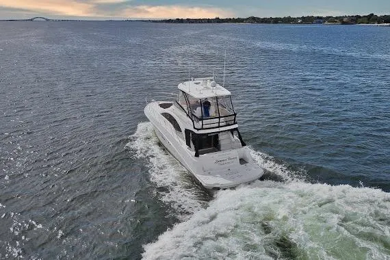 Slide: The Image of 2008 Sea Ray 47 Sedan Bridge cruising on open water at sunset. - 5