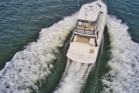 Slide: The Image of 2008 Sea Ray 47 Sedan Bridge cruising on open water, aerial view. - 7