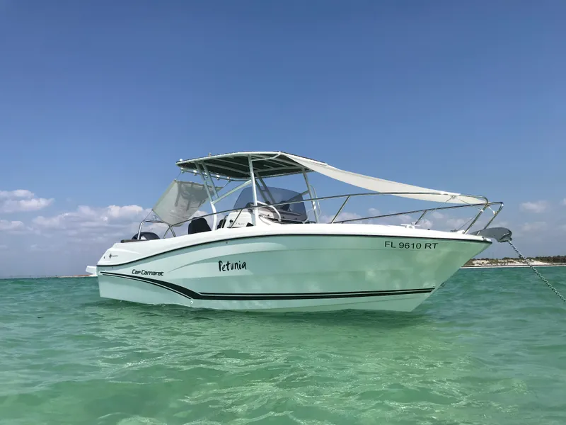 Slide: The Image of 2019 Jeanneau Leader 7.5 CC boat anchored in clear turquoise water under a blue sky. - 0