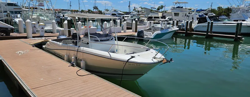 Slide: The Image of 2019 Jeanneau Leader 7.5 CC boat docked in a marina, surrounded by other vessels. - 1