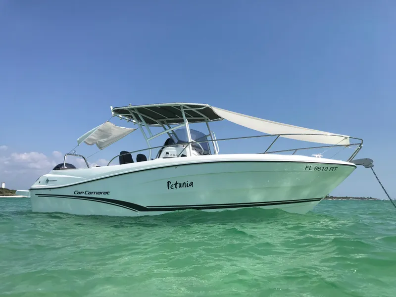 Slide: The Image of 2019 Jeanneau Leader 7.5 CC boat anchored in clear turquoise water. - 22