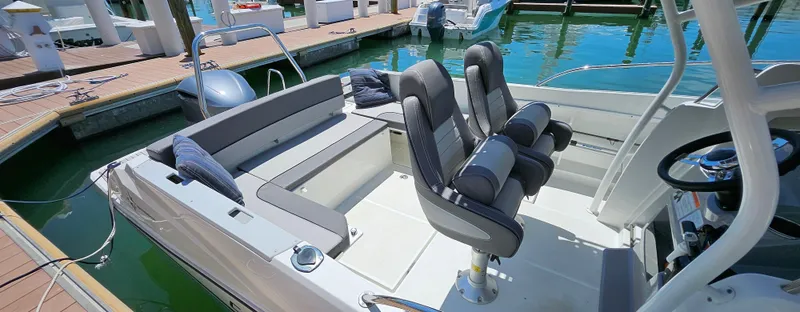 Slide: The Image of 2019 Jeanneau Leader 7.5 CC boat interior with seating, docked at marina. - 6