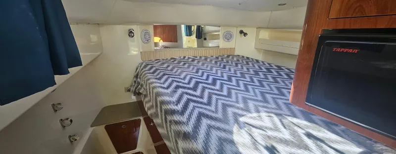 Slide: The Image of 2008 World Cat 320 EC cabin interior with bed and compact fridge. - 15