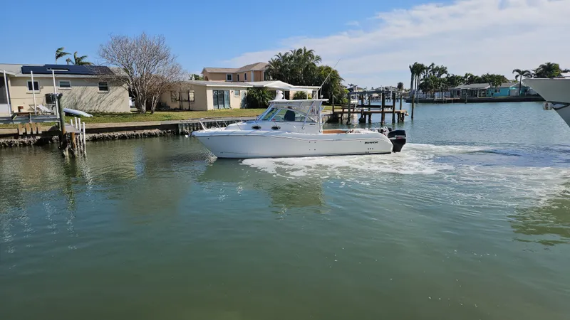 Slide: The Image of 2008 World Cat 320 EC cruising in a calm residential waterway. - 18