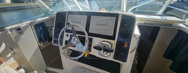 Slide: The Image of 2008 World Cat 320 EC boat helm with Garmin navigation displays. - 6