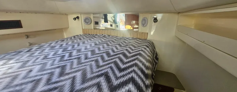 Slide: The Image of 2008 World Cat 320 EC cabin interior with chevron-patterned bedding. - 7