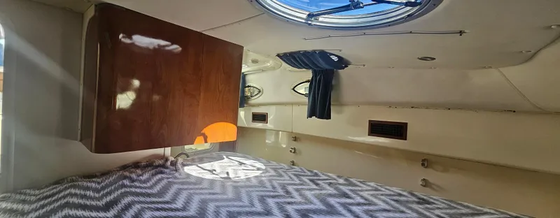 Slide: The Image of Interior cabin of 2008 World Cat 320 EC with bed and wooden cabinet. - 8