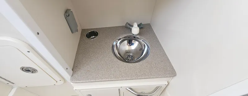 Slide: The Image of Compact sink area in 2008 World Cat 320 EC boat interior. - 9