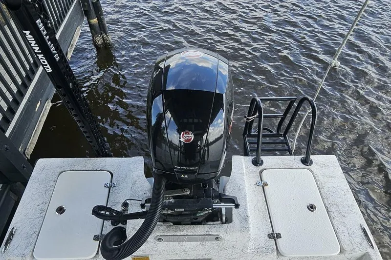 Slide: The Image of 2021 Flats Cat 21' boat with outboard motor and Minn Kota trolling motor on water. - 20