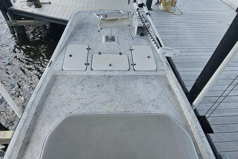 Slide: The Image of 2021 Flats Cat 21' boat deck with storage compartments and trolling motor at dock. - 22
