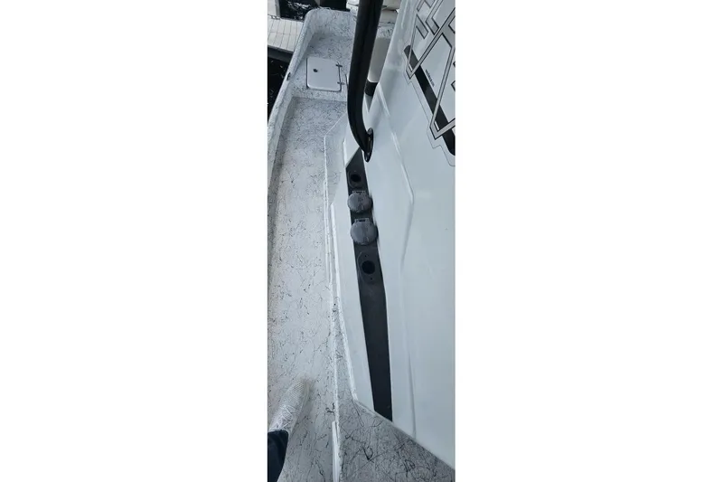 Slide: The Image of 2021 Flats Cat 21' boat interior with textured flooring and side rail detail. - 23