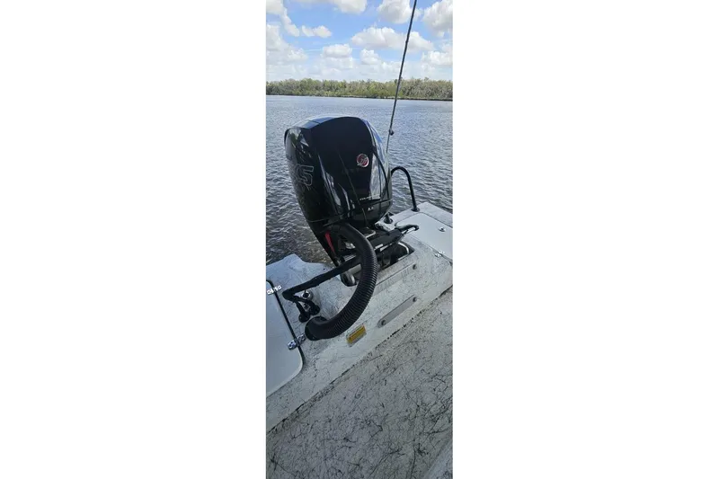 Slide: The Image of 2021 Flats Cat 21' boat with outboard motor on a calm lake. - 9