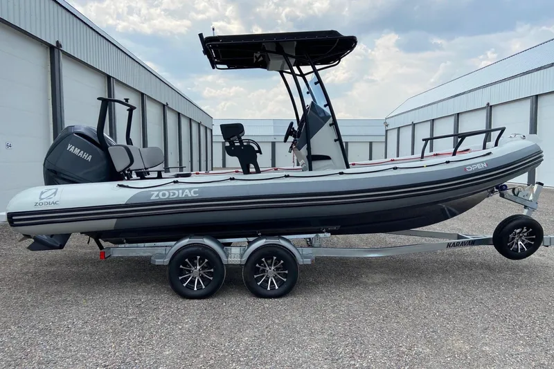 Slide: The Image of 2023 Zodiac Pro Open boat on trailer, featuring Yamaha engine, parked outdoors. - 3