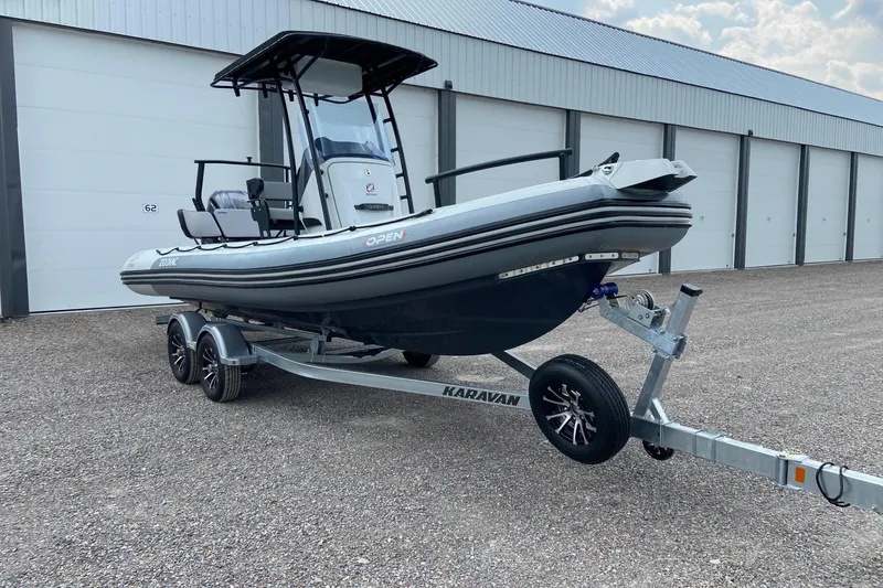 Slide: The Image of 2023 Zodiac Pro Open boat on Karavan trailer, parked outside storage facility. - 4