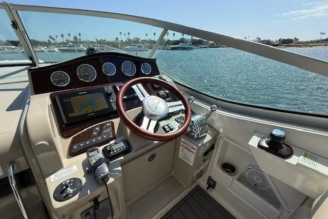 Slide: The Image of Helm of 2012 Sea Ray 330 Sundancer with navigation controls and ocean view. - 12