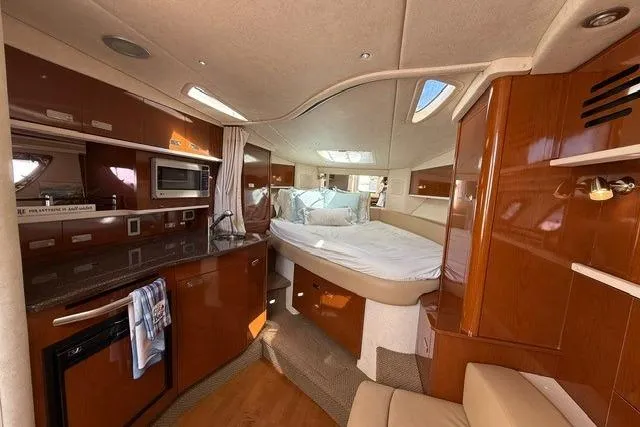 Slide: The Image of Luxurious interior of 2012 Sea Ray 330 Sundancer yacht with cozy bed and kitchenette. - 17
