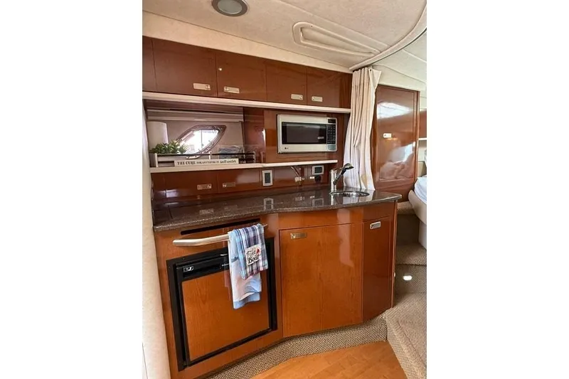 Slide: The Image of Interior of 2012 Sea Ray 330 Sundancer yacht with kitchenette and microwave. - 18