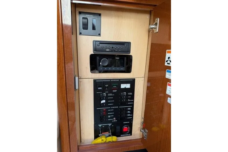 Slide: The Image of 2012 Sea Ray 330 Sundancer control panel with switches and audio system. - 26