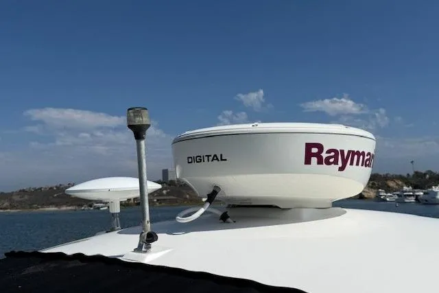 Slide: The Image of Radar equipment on 2012 Sea Ray 330 Sundancer boat under clear blue sky. - 28