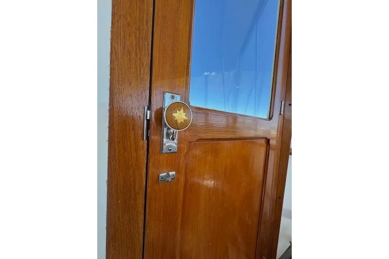 Slide: The Image of Wooden door with star emblem on a 1974 Chris-Craft 47 Commander yacht. - 11