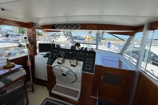 Slide: The Image of 1974 Chris-Craft 47 Commander helm with classic wooden dashboard and modern navigation equipment. - 12