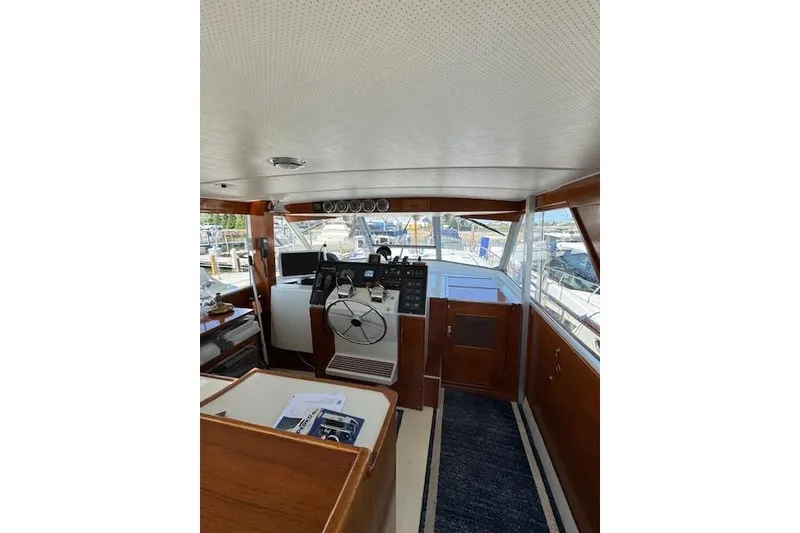 Slide: The Image of Interior of 1974 Chris-Craft 47 Commander yacht with wooden helm and navigation equipment. - 18