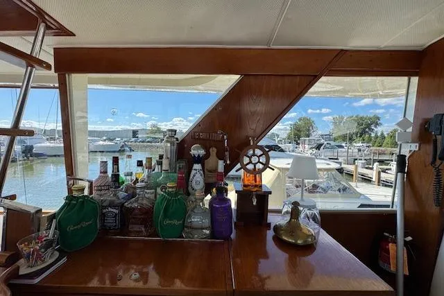 Slide: The Image of Interior of 1974 Chris-Craft 47 Commander with bar setup and marina view. - 20