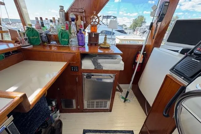 Slide: The Image of 1974 Chris-Craft 47 Commander interior with bar setup and nautical decor. - 21