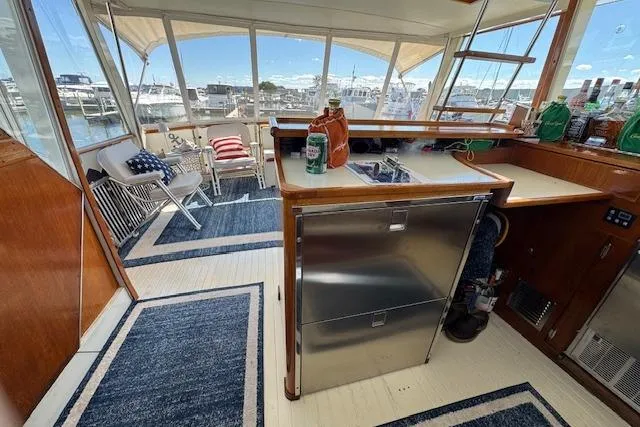Slide: The Image of 1974 Chris-Craft 47 Commander interior with nautical decor and marina view. - 22